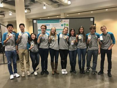 The Air Force Research Laboratory-Carroll High School iGEM team proudly displays their gold medals after the international iGEM competition in Boston Nov. 13, 2017. (U.S. Air Force photo/Richard Eldridge)